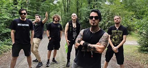 The band standing together on a forest path