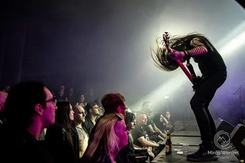 Bassist headbanging over the front row