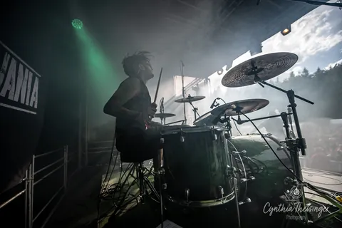 Drummer behind the kit in green smoke