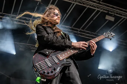 Bassist mid swing, hair across his face